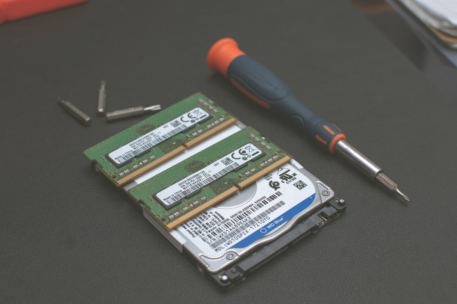A hard disk drive with screwdriver being repaired